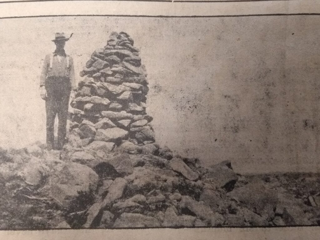 William Crowshaw standing next to Mount Albert Edward’s summit cairn, 1929.