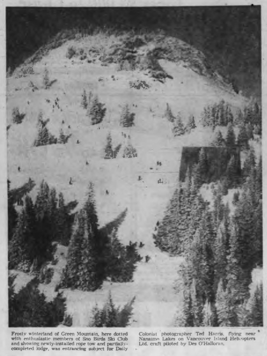Frosty winterland of Green Mountain, here dotted with enthusiastic members of Sno Birds Ski Cluband showing newly-installed rope tow and partially-completed lodge, was entrancing subject for Daily Colonist photographer Ted Harris, flying near Nanaimo Lakes on Vancouver Island Helicopters Ltd. craft piloted by Des O'Halloran.
