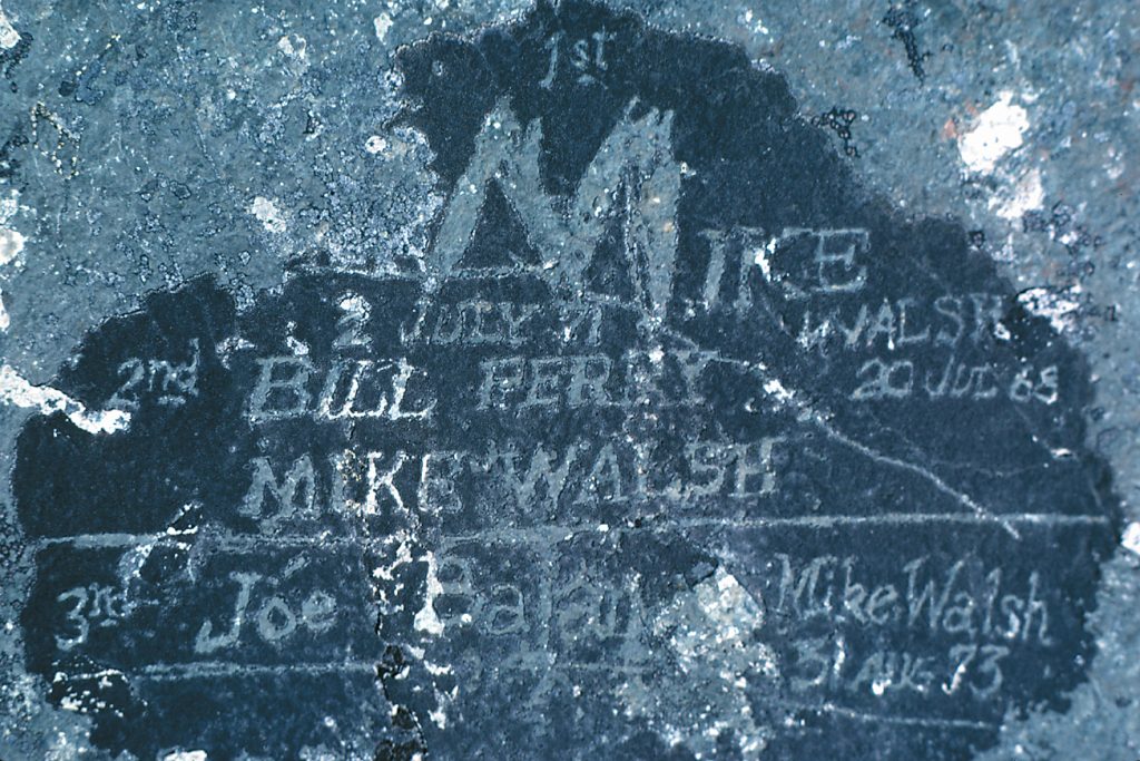 Names of the first three ascents of Mt. Colonel Foster etched into lichen along the summit ridge. Found in 1982 – Don Berryman photo.