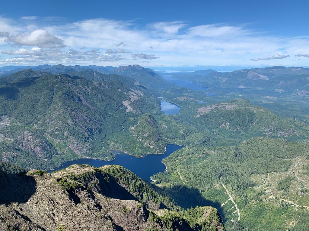 The view from the summit of Pinder Peak looking down on Atluck Lake with Nimpkish Lake in the distance – Chauncey McEachern photo.