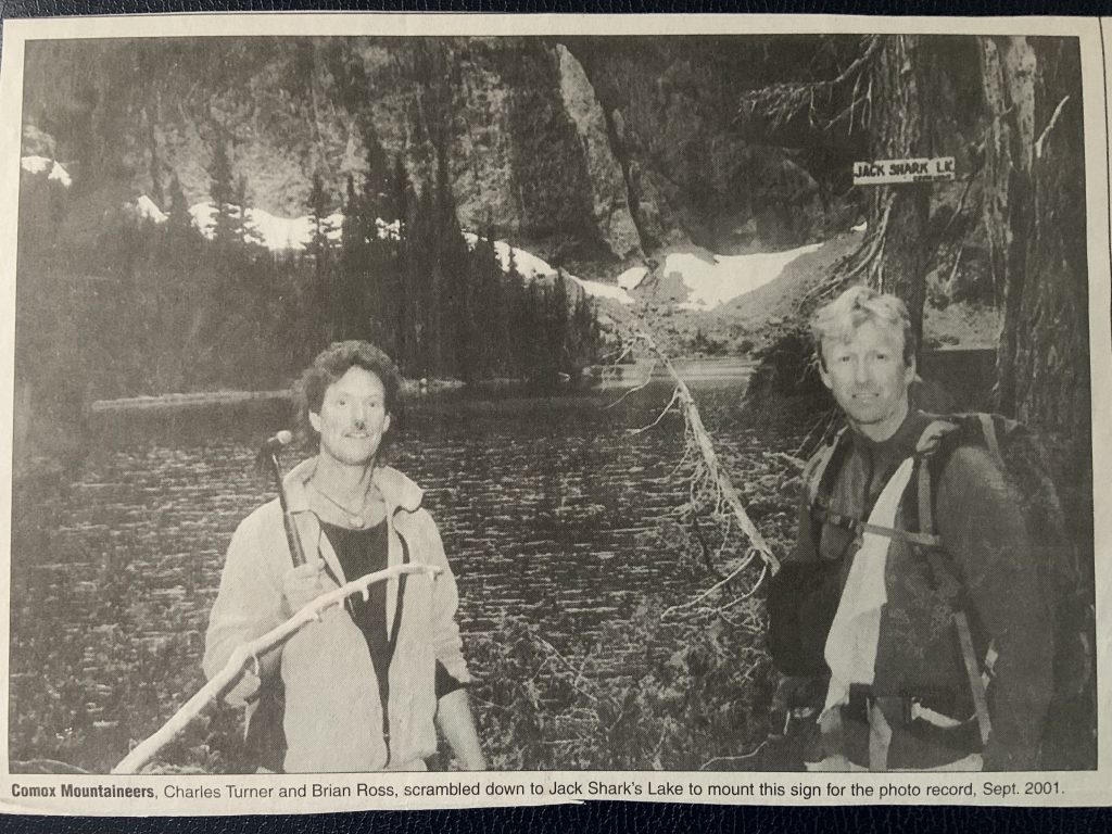 Comox Mountaineers, Charles Turner and Brian Ross, scrambled down to Jack Shark’s Lake to mount this sign for the photo record, Sept, 2001.