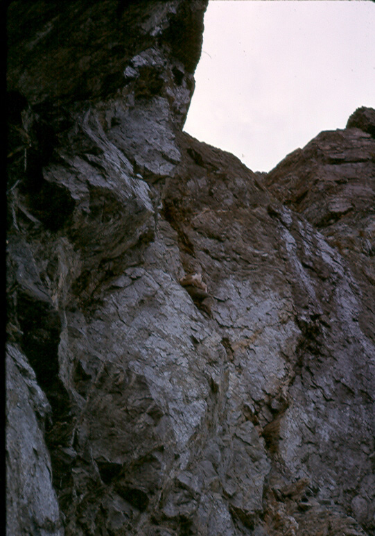 Climber (possibly Ron Facer) ascending the west gully up to the ridge on the Southwest Summit of Mt. Colonel Foster, August 1, 1966 - Ralph Hutchinson photo.