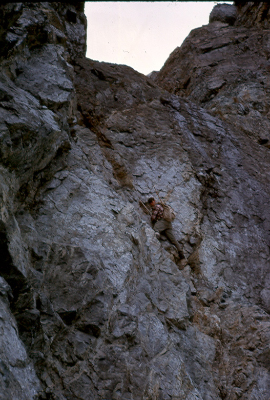 Climber (possibly Ron Facer) ascending the west gully up to the ridge on the Southwest Summit of Mt. Colonel Foster, August 1, 1966 - Ralph Hutchinson photo.