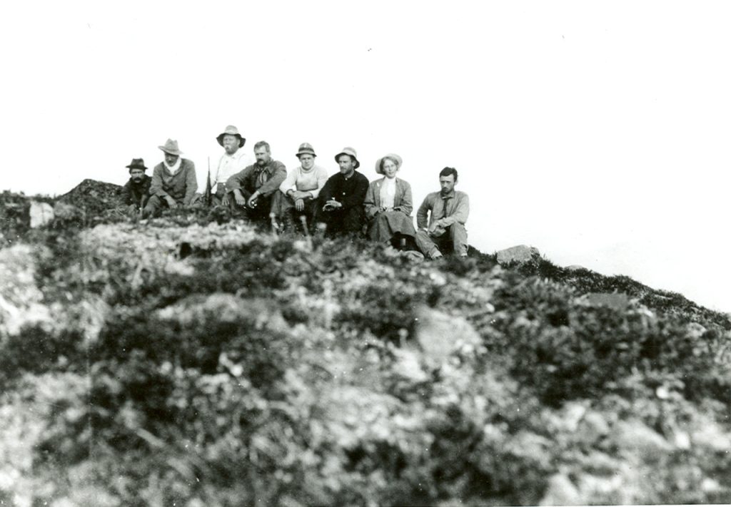 Expedition members sitting on the summit of Ellison Peak, Crown Mountain.